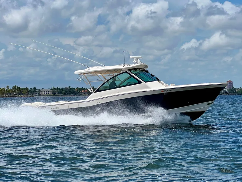 Slide: The Image of 2021 Grady-White Freedom 375 boat cruising on open water under a cloudy sky. - 5