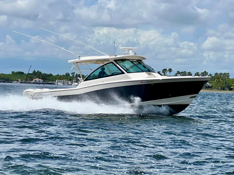 Slide: The Image of 2021 Grady-White Freedom 375 cruising on open water under a cloudy sky. - 6