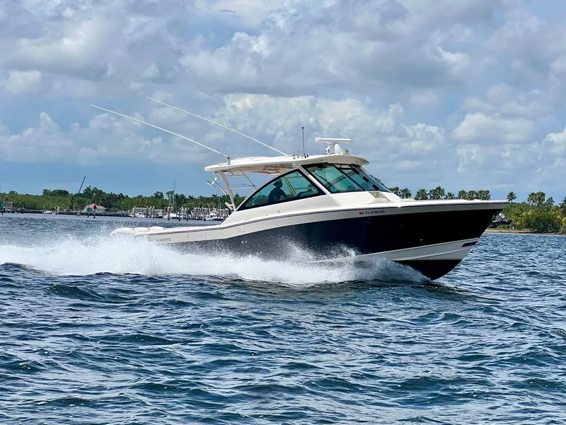 Slide: The Image of 2021 Grady-White Freedom 375 boat cruising on open water under a cloudy sky. - 7