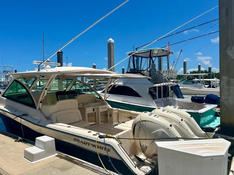 Slide: The Image of 2021 Grady-White Freedom 375 boat docked at a marina on a sunny day. - 9