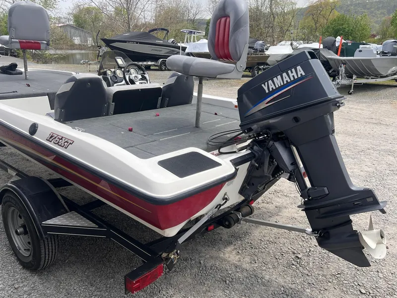 Slide: The Image of 2007 Stratos 176XT boat with Yamaha outboard motor, parked on gravel. - 11