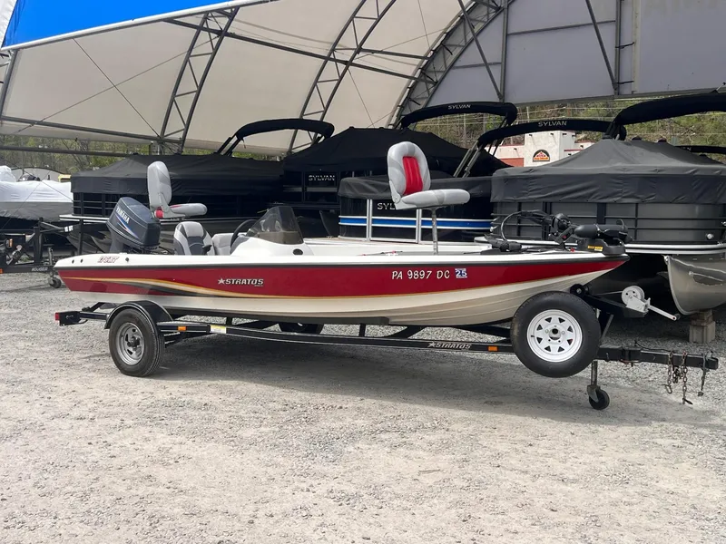 Slide: The Image of 2007 Stratos 176XT boat on trailer, parked under a canopy. - 13