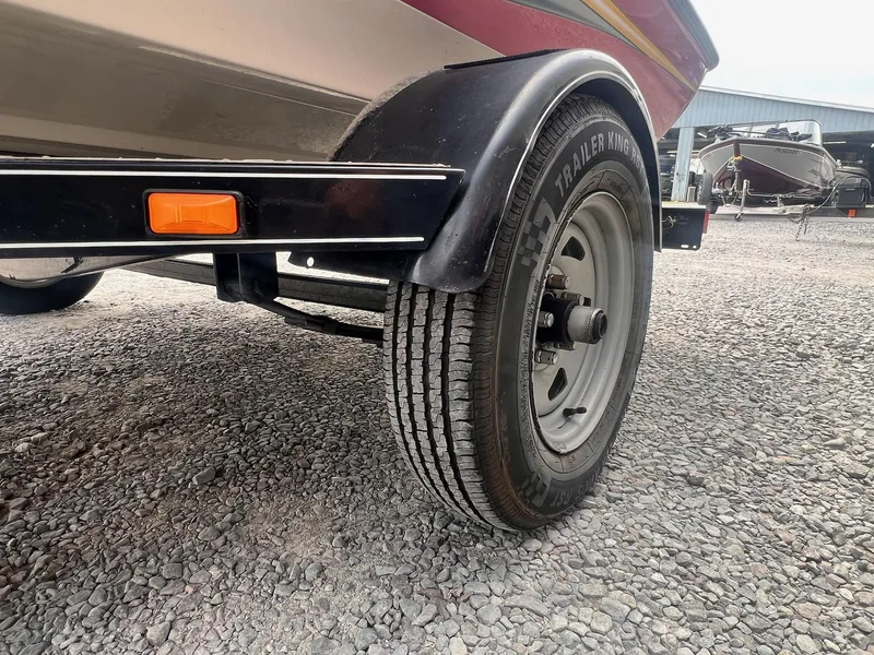 Slide: The Image of Trailer wheel of a 2007 Stratos 176XT boat on gravel surface. - 14