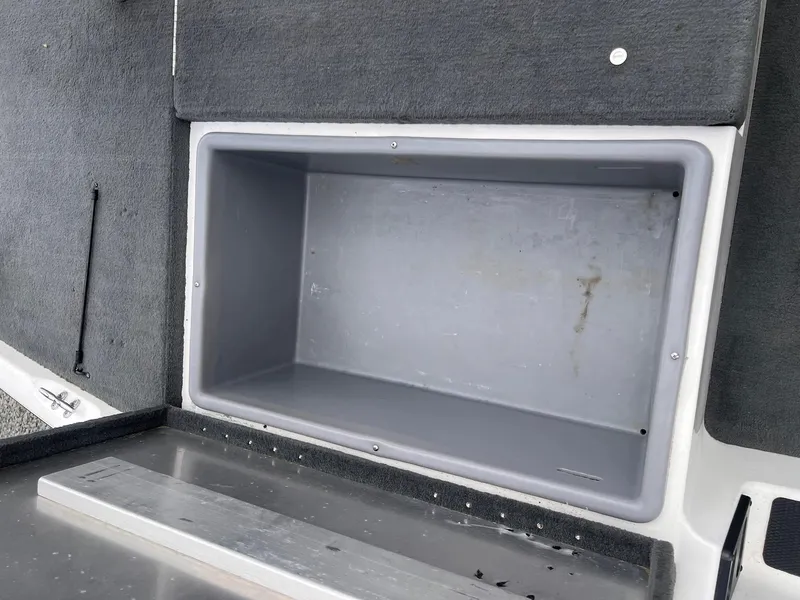Slide: The Image of Empty storage compartment in a 2007 Stratos 176XT boat interior. - 16