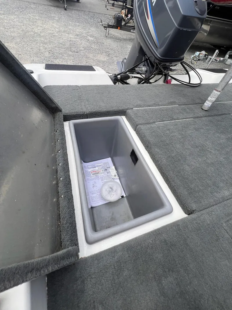 Slide: The Image of Open storage compartment on a 2007 Stratos 176XT boat, showing documents inside. - 20