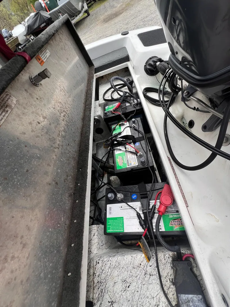 Slide: The Image of Open battery compartment of a 2007 Stratos 176XT boat, showing multiple batteries and wiring. - 21