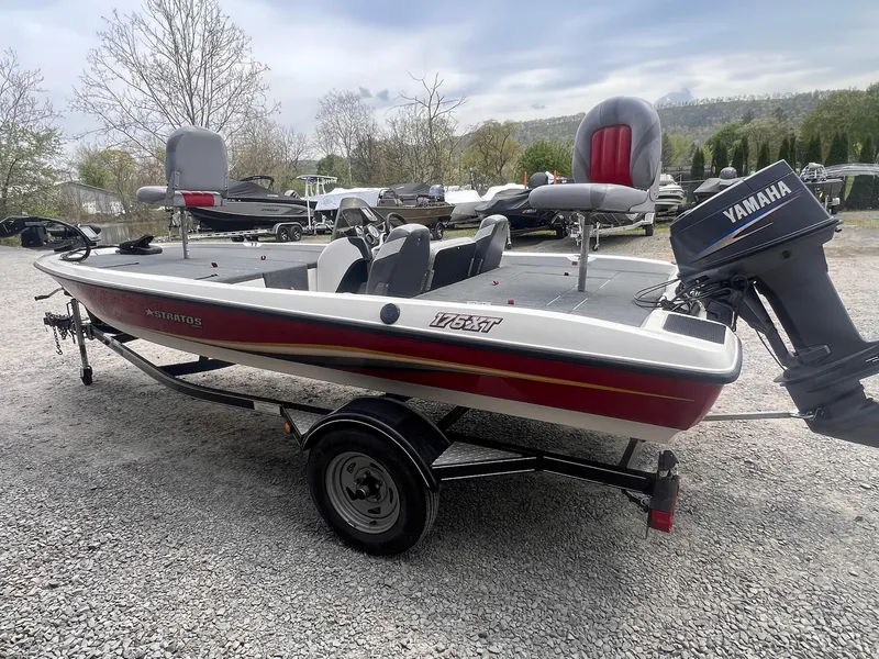 Slide: The Image of 2007 Stratos 176XT boat with Yamaha motor on a trailer, parked outdoors. - 22