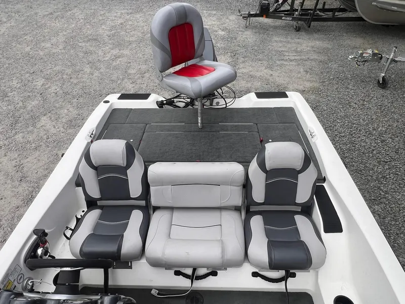 Slide: The Image of 2007 Stratos 176XT boat interior with gray and red seating on gravel surface. - 25