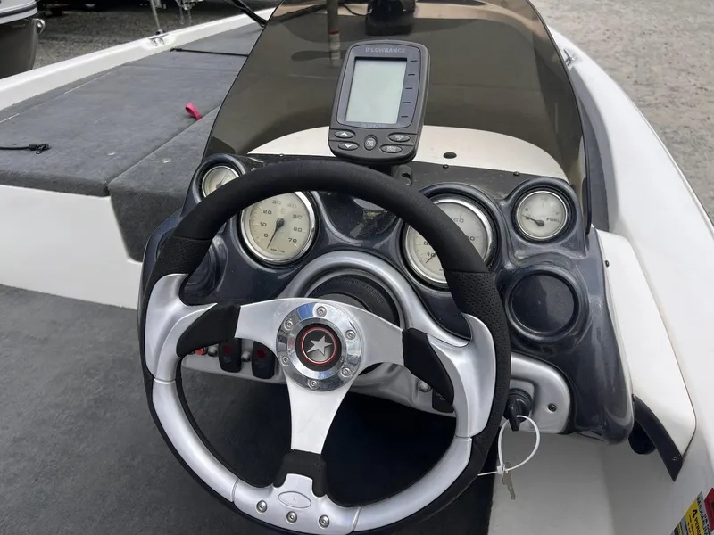 Slide: The Image of Steering wheel and dashboard of a 2007 Stratos 176XT boat with gauges and GPS. - 32