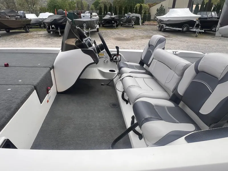 Slide: The Image of 2007 Stratos 176XT boat interior with gray and white seating, steering wheel, and dashboard. - 9