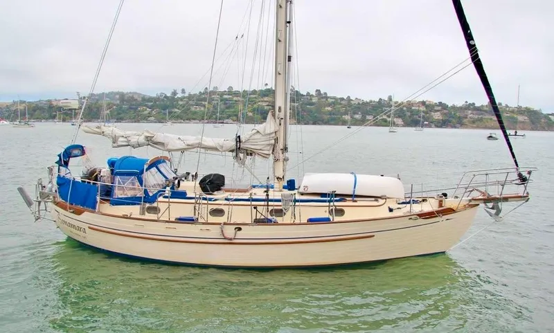 Slide: The Image of 1984 Tayana Sloop Rigged Cutter sailboat anchored in calm waters. - 0