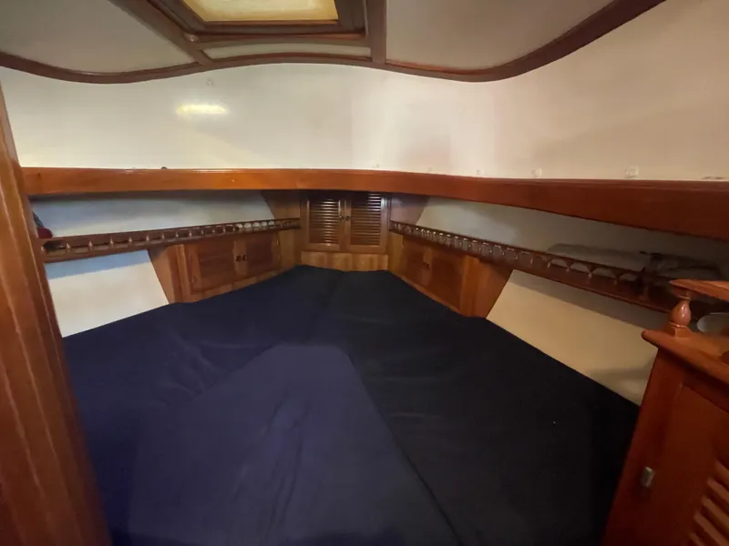 Slide: The Image of 1984 Tayana Sloop Rigged Cutter interior cabin with wooden finish and spacious sleeping area. - 17