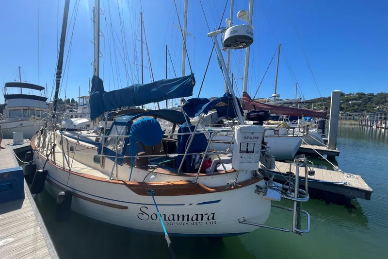 Slide: The Image of 1984 Tayana Sloop Rigged Cutter docked at marina under clear blue sky. - 6