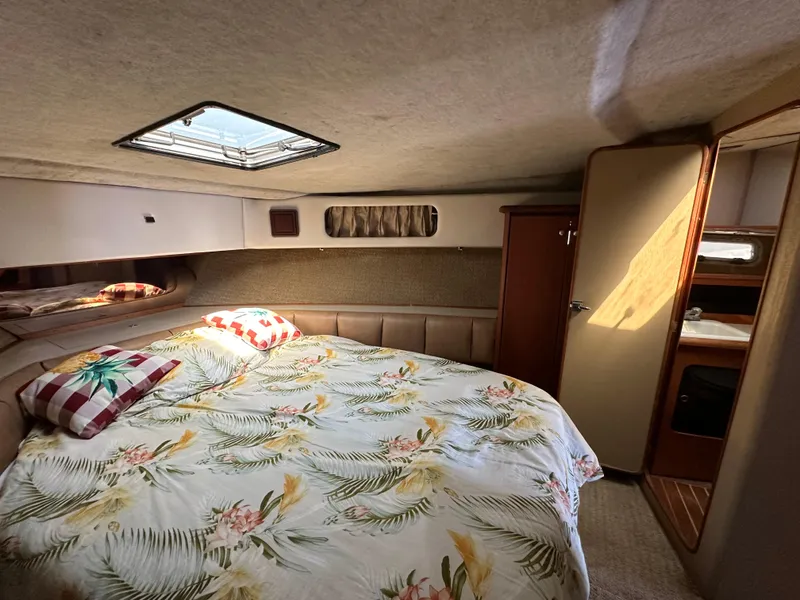 Slide: The Image of 1987 Bayliner 3888 Motoryacht cabin with floral bedding and natural light. - 14