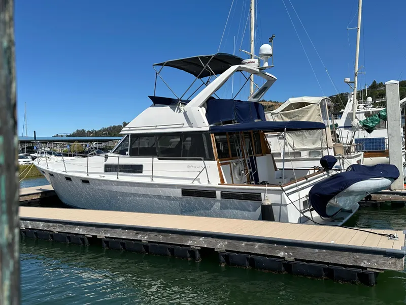 Slide: The Image of 1987 Bayliner 3888 Motoryacht docked at marina under clear blue sky. - 17