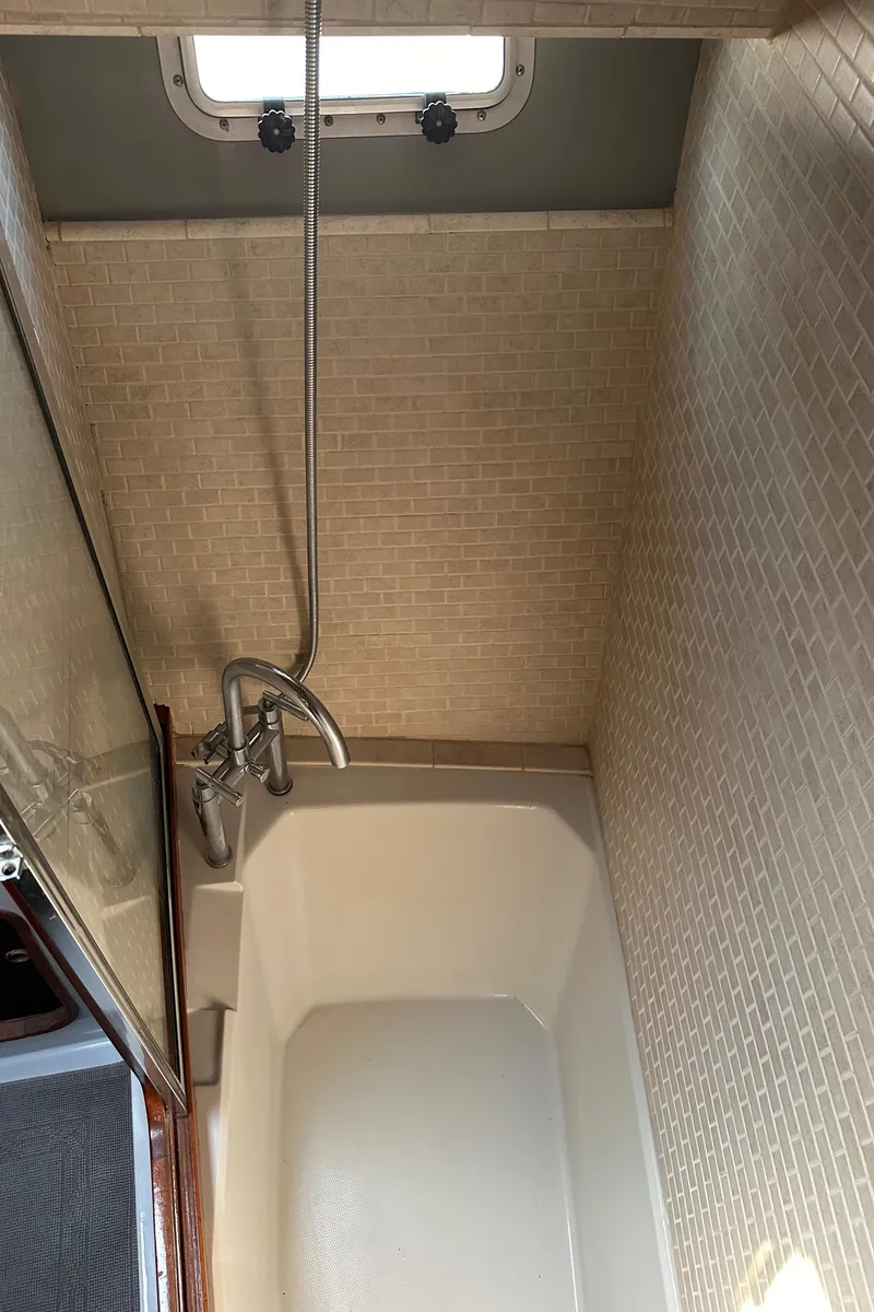 Slide: The Image of Shower area in 1987 Bayliner 3888 Motoryacht with tiled walls and window. - 19