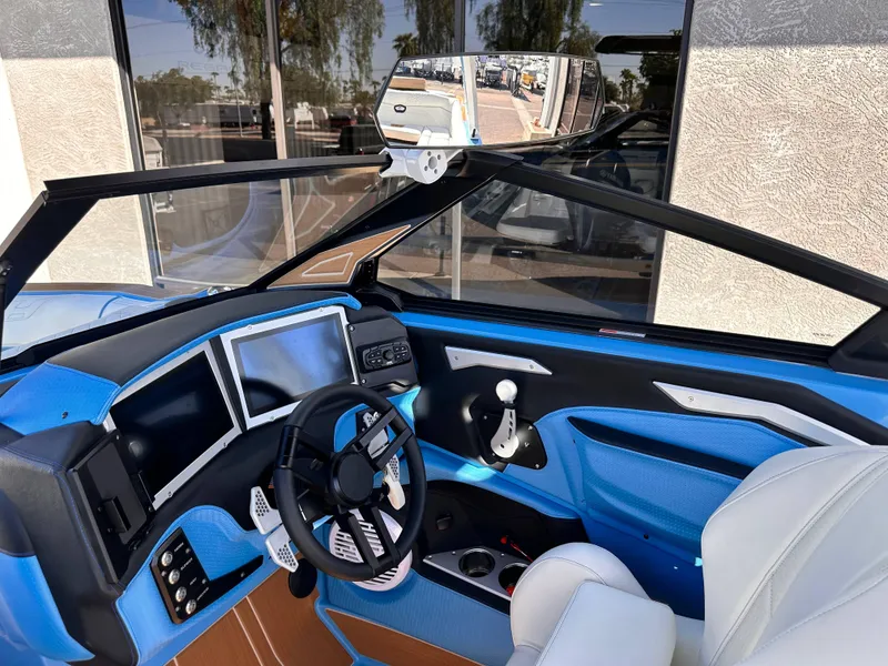 Slide: The Image of 2024 Centurion Ri265 boat interior with modern dashboard and steering wheel. - 10