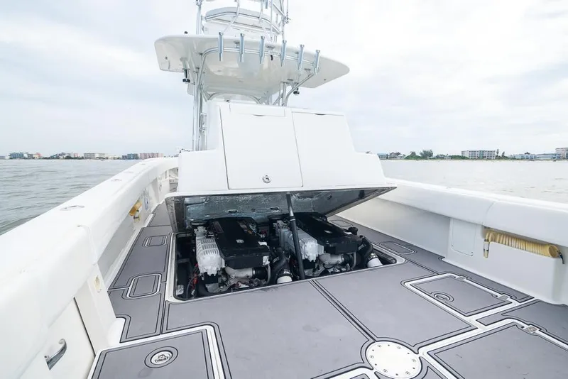 Slide: The Image of 2009 SeaVee 390I boat with open engine compartment on the water. - 13