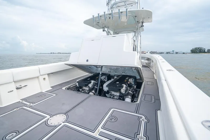 Slide: The Image of 2009 SeaVee 390I boat with open engine compartment on calm waters. - 14