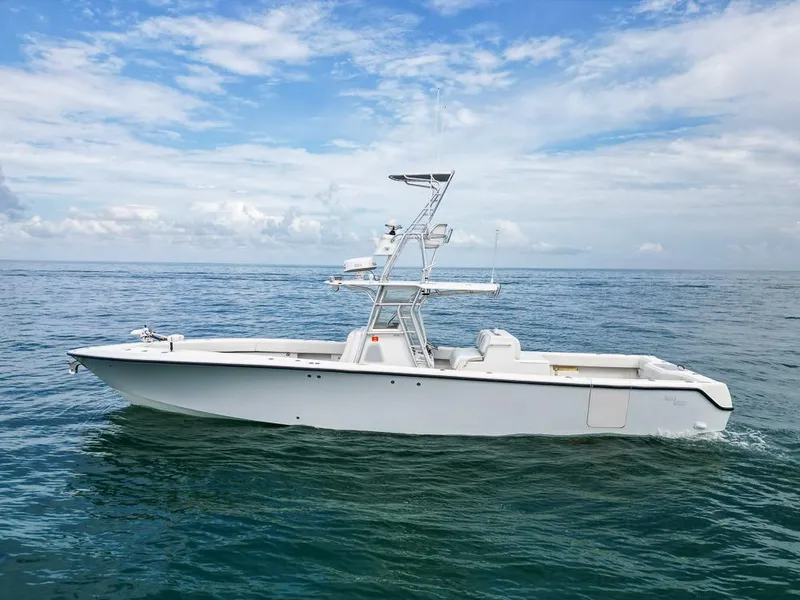 Slide: The Image of 2009 SeaVee 390I boat on calm ocean waters under a partly cloudy sky. - 2