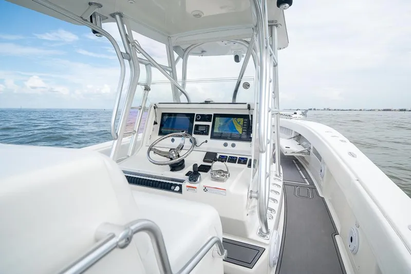 Slide: The Image of 2009 SeaVee 390I boat helm with navigation screens on open water. - 22