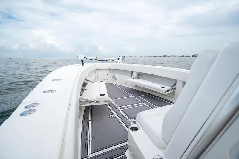 Slide: The Image of 2009 SeaVee 390I boat deck with seating, ocean view, and cloudy sky. - 26