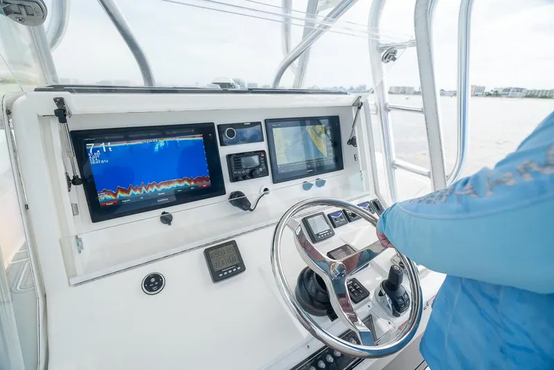 Slide: The Image of 2009 SeaVee 390I boat dashboard with navigation and fish-finding equipment. - 27