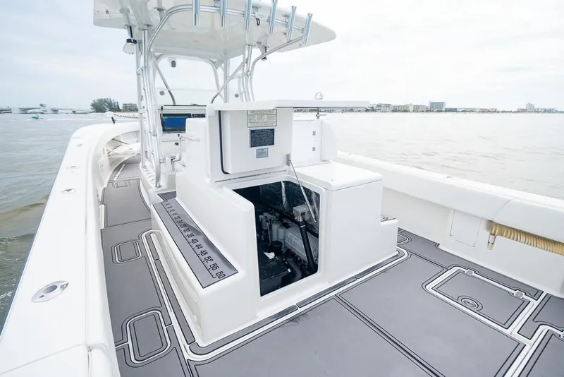 Slide: The Image of 2009 SeaVee 390I boat deck with open storage compartment on calm waters. - 28