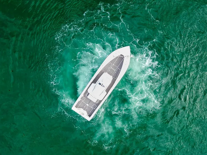 Slide: The Image of Aerial view of a 2009 SeaVee 390I boat navigating turquoise waters. - 5