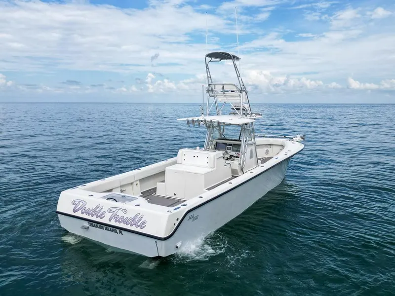 Slide: The Image of 2009 SeaVee 390I boat on open water with Double Trouble name on stern. - 7