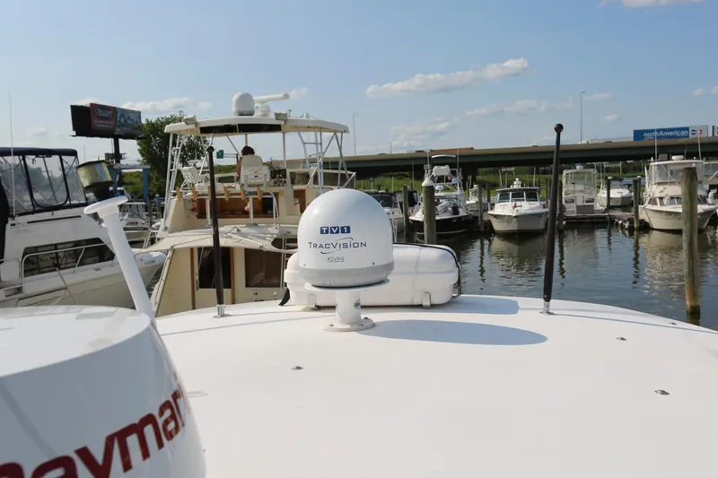 Slide: The Image of Wellcraft 330 Coastal 2005 docked at marina with Raymarine and TracVision equipment. - 13