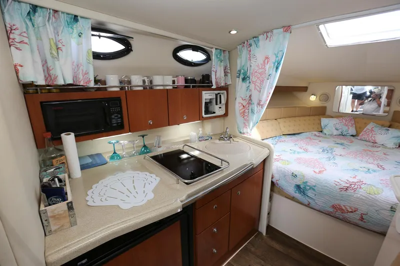 Slide: The Image of 2005 Wellcraft 330 Coastal interior with kitchen and cozy sleeping area. - 15