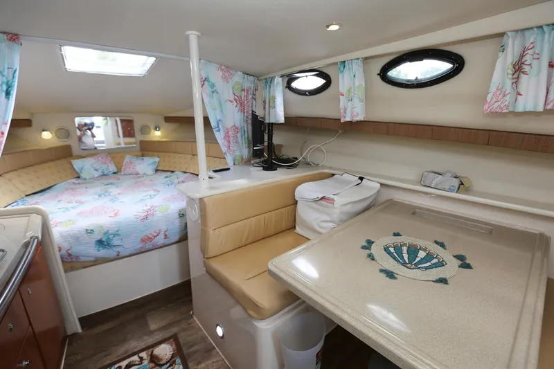 Slide: The Image of Interior cabin of 2005 Wellcraft 330 Coastal boat with bed and dining area. - 16