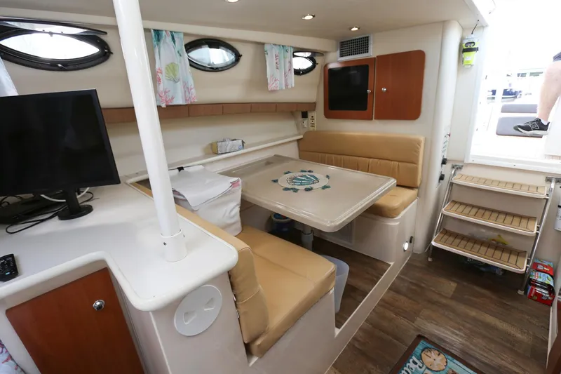 Slide: The Image of Interior of 2005 Wellcraft 330 Coastal boat with dining area and TV. - 18