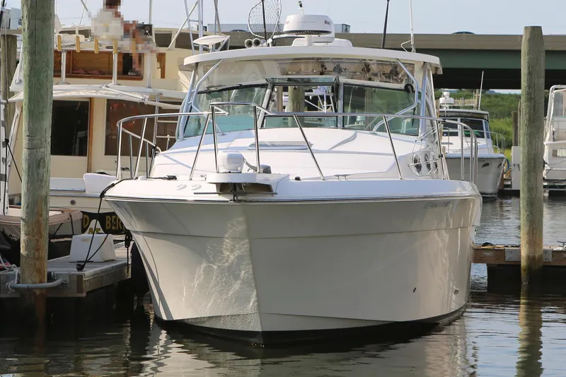 Slide: The Image of 2005 Wellcraft 330 Coastal boat docked at a marina. - 2