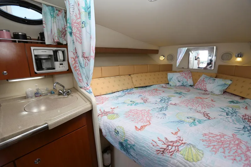 Slide: The Image of 2005 Wellcraft 330 Coastal cabin with bed, kitchenette, and porthole window. - 22