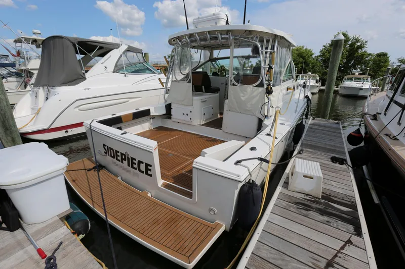 Slide: The Image of 2005 Wellcraft 330 Coastal boat docked at marina, rear view. - 3