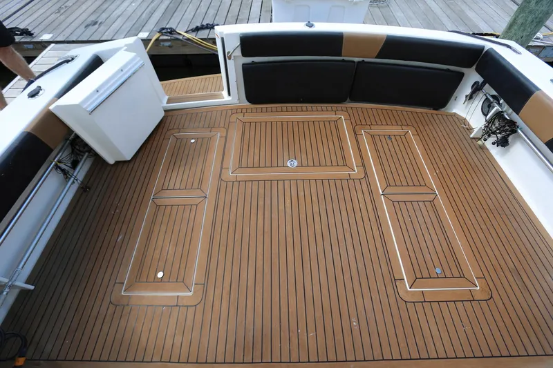 Slide: The Image of 2005 Wellcraft 330 Coastal boat deck with teak flooring and cushioned seating. - 4
