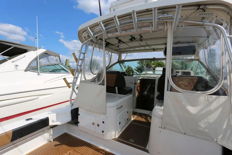 Slide: The Image of 2005 Wellcraft 330 Coastal boat with open cockpit and seating area. - 6
