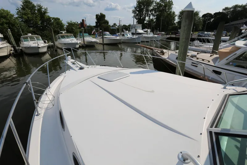 Slide: The Image of 2005 Wellcraft 330 Coastal boat docked at a marina with other boats. - 8