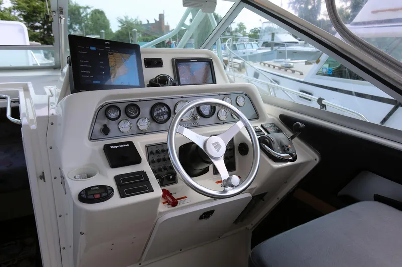 Slide: The Image of 2005 Wellcraft 330 Coastal boat helm with navigation screens and control panel. - 9