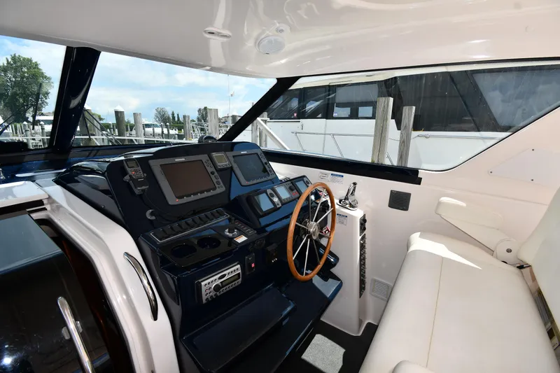 Slide: The Image of 2007 Tiara Yachts 4700 Sovran helm station with modern navigation equipment and comfortable seating. - 12