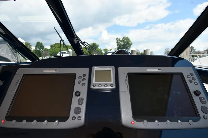 Slide: The Image of Dashboard of a 2007 Tiara Yachts 4700 Sovran with navigation screens. - 14