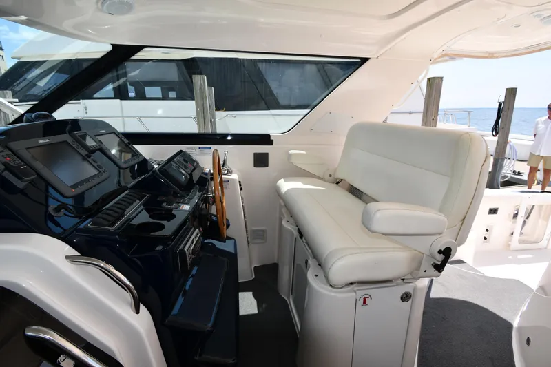 Slide: The Image of 2007 Tiara Yachts 4700 Sovran helm station with white seating and navigation equipment. - 19