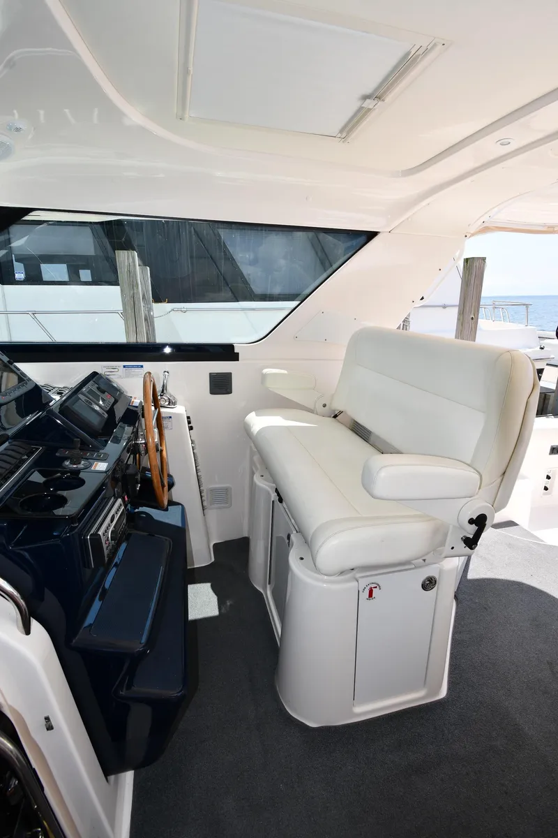Slide: The Image of 2007 Tiara Yachts 4700 Sovran helm station with white seating. - 20