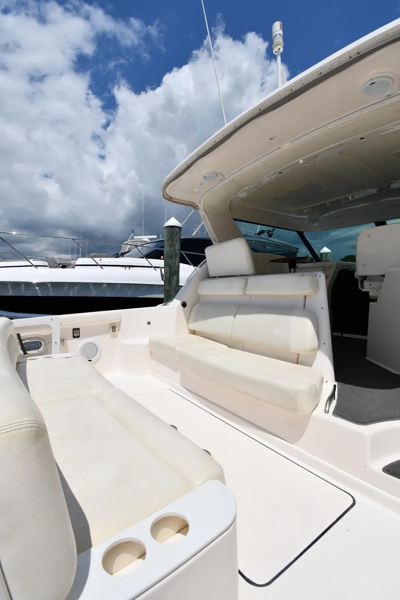 Slide: The Image of 2007 Tiara Yachts 4700 Sovran cockpit with white seating and cup holders. - 24