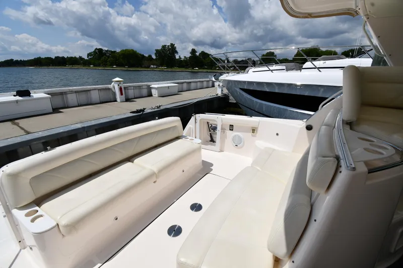 Slide: The Image of 2007 Tiara Yachts 4700 Sovran at dock, featuring spacious seating and scenic waterfront view. - 25