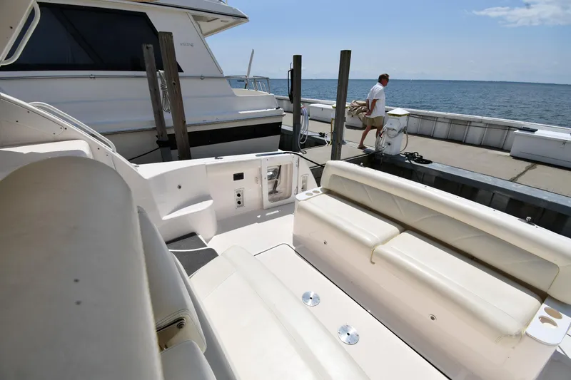 Slide: The Image of 2007 Tiara Yachts 4700 Sovran docked, featuring spacious seating and ocean view. - 26