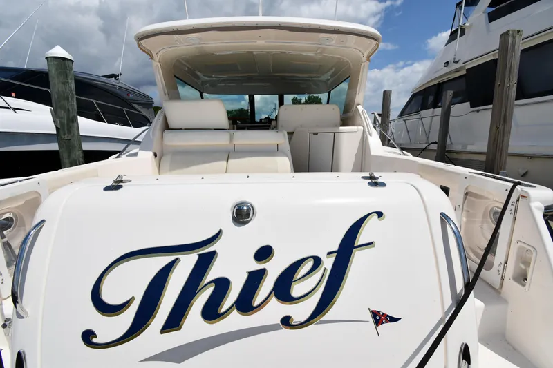 Slide: The Image of 2007 Tiara Yachts 4700 Sovran named Thief docked at a marina. - 3