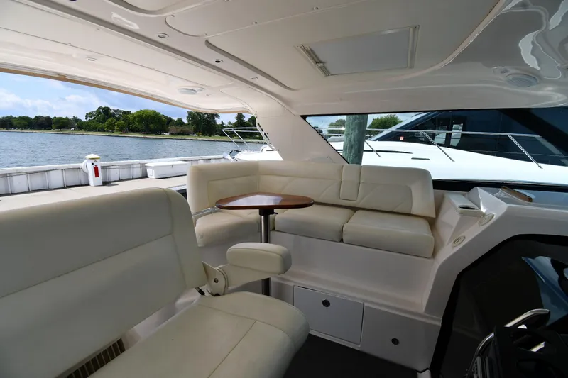 Slide: The Image of 2007 Tiara Yachts 4700 Sovran interior with white leather seating and a small table. - 31